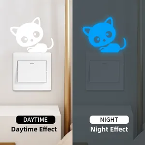 Luminous cat wall sticker for light switches showing day and night glowing blue effect