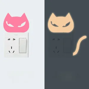 Luminous cat light switch sticker showing pink daytime look and green night glow effect