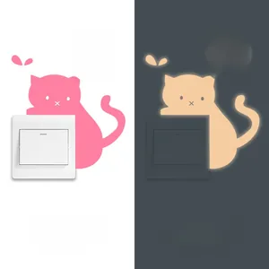 Luminous cat switch wall decal showing day and night glow effects for home decor