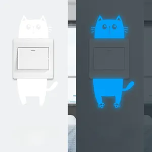 Luminous cartoon cat switch sticker showing daylight white and glowing blue night effect