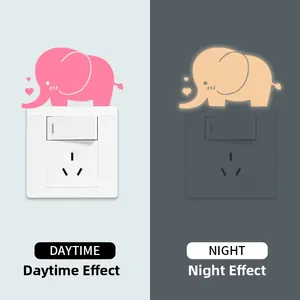 Luminous elephant wall sticker showing day and night glow effect on light switch