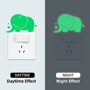 Luminous elephant wall sticker showing day and night glow effects on light switches