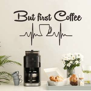Minimalist 'But first coffee' wall decal with heart line and cup on white wall background