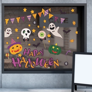 Close-up of Halloween window decals with pumpkin and ghost designs on a cafe glass pane