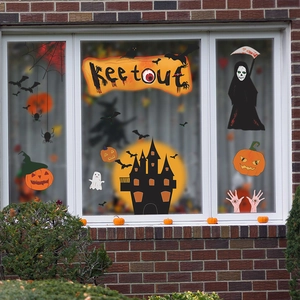 Close-up of Halloween window stickers featuring a spooky castle, pumpkins and ghosts