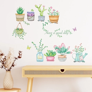 Detail of hand-painted succulent wall stickers with botanical vases on a white wall