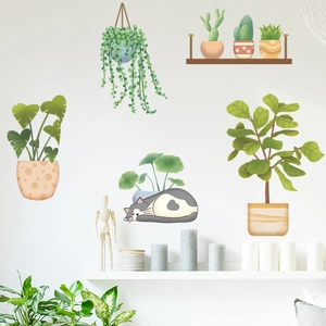 Detail of tropical plant wall stickers with succulents and a sleeping cat in living room
