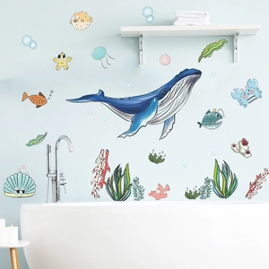 Detailed view of ocean theme wall stickers with blue whale and coral on bathroom tile