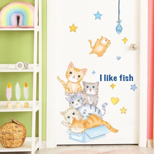 Detailed interior view of cartoon cat wall stickers on white door for kids' rooms