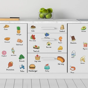Cartoon fruit and vegetable kitchen stickers displayed on white kitchen cabinets