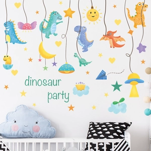 Detail of cute cartoon dinosaur wall decals with stars and moon in a nursery room decor