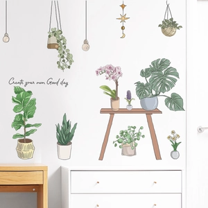 Detail of hand-drawn succulent wall stickers on white wall with wood desk setup