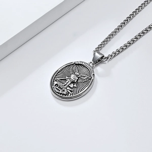 Detail of St. Michael archangel pendant with vintage oval shield and wheat chain