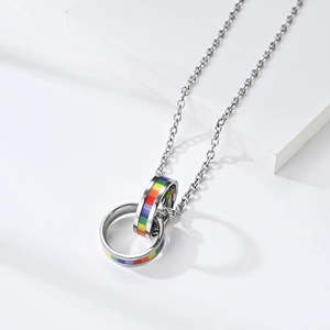 Detailed close-up of double interlocking rainbow rings on a silver chain necklace