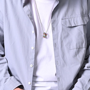 Close-up of a double-ring rainbow necklace on a model for LGBT pride style