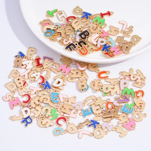 Detailed close-up of colorful enamel alphabet charms with golden finish for DIY jewelry
