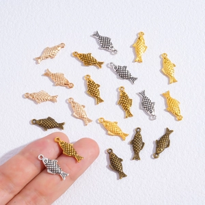 Assorted vintage metal koi fish pendants for DIY jewelry making in multiple metallic colors