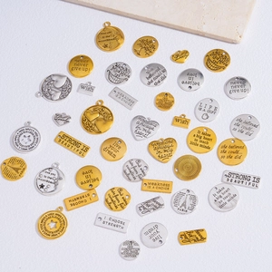 Assorted gold and silver metal inspirational quote charms for DIY jewelry making