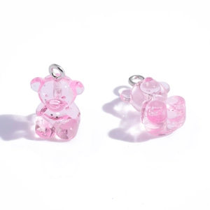 Translucent pink resin bear pendant charms with silver metal rings on a white background