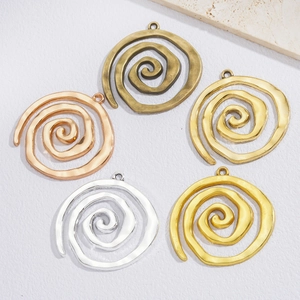 Set of five spiral metal alloy swirl pendants in antique bronze, silver, and gold finishes