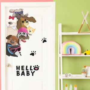 Close-up of cute cartoon dog wall stickers with Hello Baby text on a white door panel
