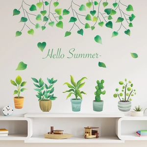 Detail view of hanging green leaves and potted succulent wall stickers on a clean white wall