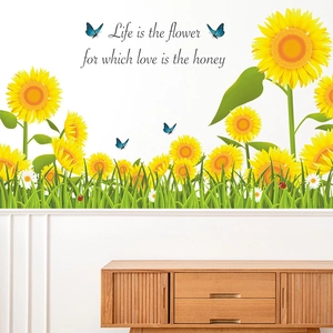 Detail of sunflower wall sticker with Life is the flower quote on white bedroom wall