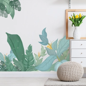 Detail of tropical monstera leaf wall stickers applied on white living room wall
