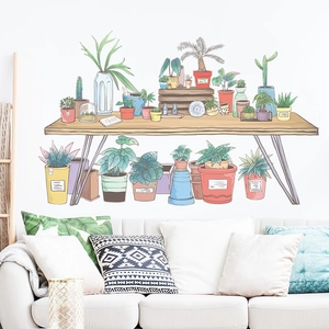 Hand-painted green plant wall stickers featuring potted succulents on a wooden table desk