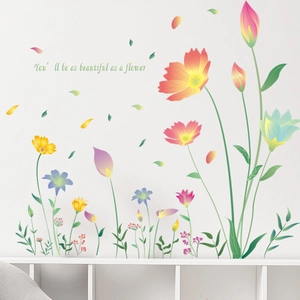Close-up of colorful flower wall stickers with inspirational quote on white wall