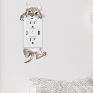 3D grey tabby cat wall sticker surrounding an American electrical socket on a white wall