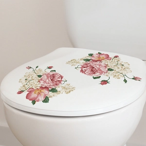 Close-up of pink peony flower decals on a modern minimalist white toilet lid
