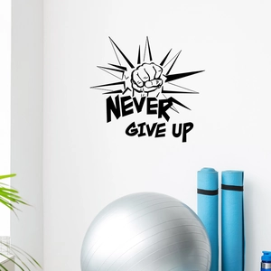 Close-up of Never Give Up wall sticker featuring a fist icon in a home gym setting