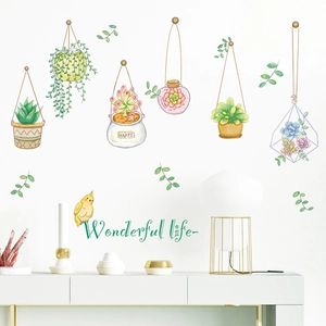 Detail of hand-painted potted plant wall stickers with birds on white interior wall