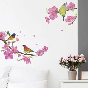 Detail of bird and cherry blossom wall stickers on white bedroom wall for home decor