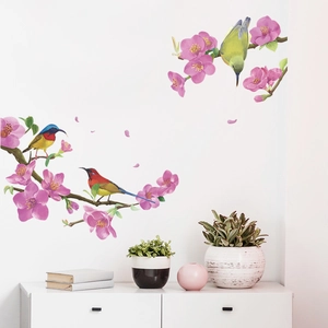 Detail of pink plum blossoms and colorful birds wall decals in a modern living room decor