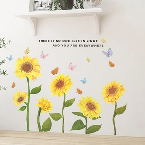 Detail of sunflower and butterfly wall stickers with quote on white living room wall
