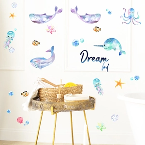 Close-up of watercolor whale and octopus wall decals in a bright nursery setting