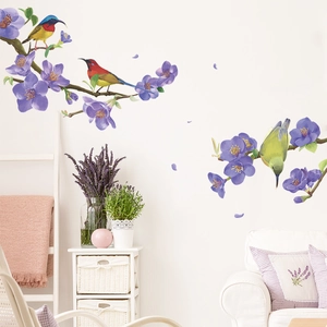 Detail view of purple plum blossom wall stickers with birds in a cozy home interior