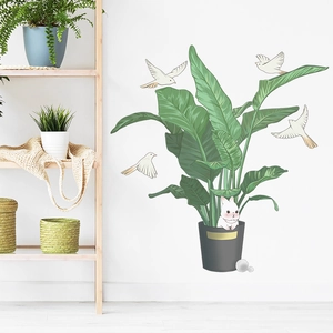 Detail of adhesive wall decals featuring green potted plants, white rabbits, and flying birds