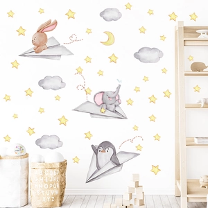 Cute wall decals featuring cartoon animals flying paper planes among yellow stars and clouds
