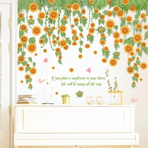 Detail of sunflower wall decals with butterfly and quote on a modern white wall