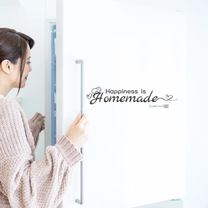 Close-up of Happiness is Homemade wall decal with chef hat icon on a white fridge