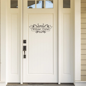 Self-adhesive Welcome Friends wall decal with floral vine border on a white wooden door
