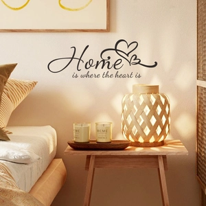 Home is where the heart is wall decal with twin hearts over a cozy bedroom headboard