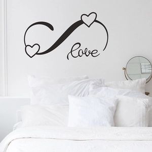 Détail macro du sticker mural noir Love Infinity sur un fond de chambre minimaliste