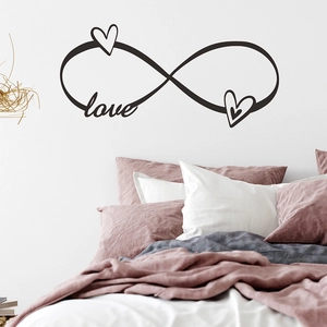 Detail of infinity symbol wall sticker with love and heart elements in a bedroom