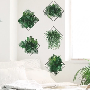 Black iron grid wall decor set with artificial monstera and fern leaves in minimalist bedroom