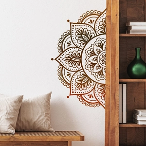 Detail of a brown mandala wall decal with bohemian patterns on a white bedroom wall