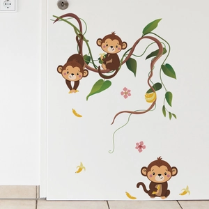 Cartoon monkey wall decals for kids room with banana and forest vines on white door